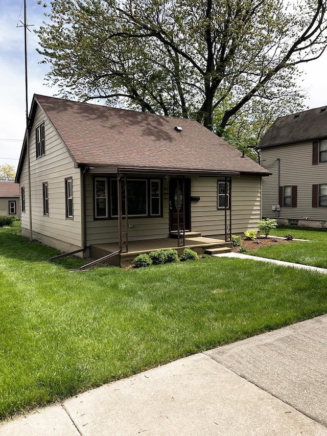 384 N Grand Ave, Bradley, IL 60915 - view of front of house with a front lawn, roof with shingles, and a porch