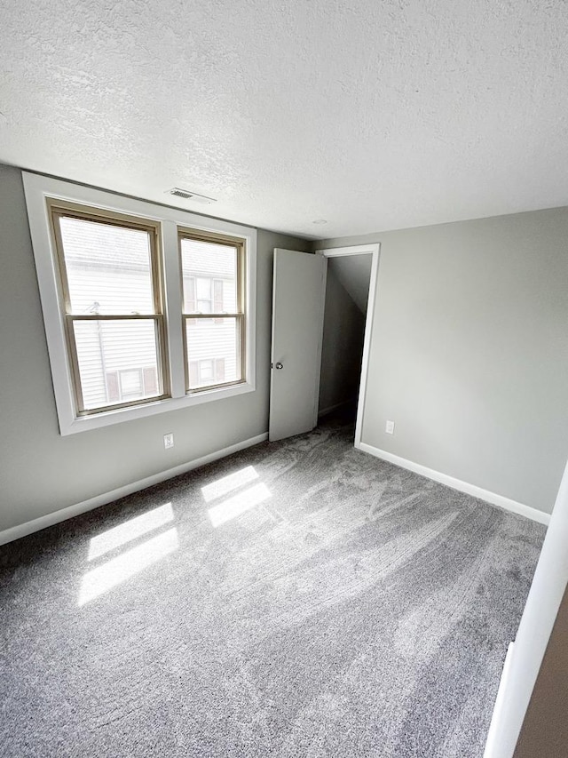 384 N Grand Ave, Bradley, IL 60915 - carpeted empty room with a textured ceiling and baseboards