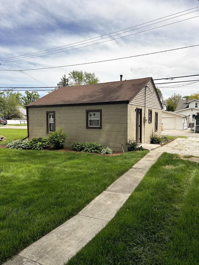 384 N Grand Ave, Bradley, IL 60915 - single story home featuring concrete block siding, a front lawn, and a shingled roof