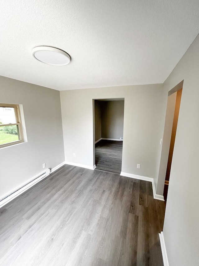 384 N Grand Ave, Bradley, IL 60915 - spare room featuring wood finished floors, baseboards, and a baseboard heating unit