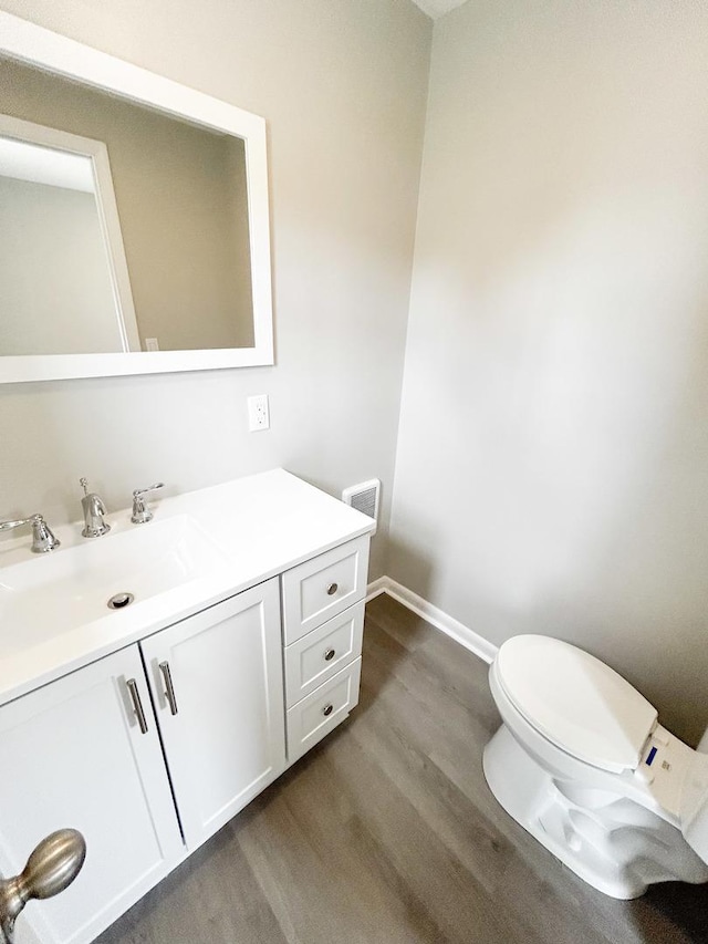 384 N Grand Ave, Bradley, IL 60915 - half bath with wood finished floors, vanity, baseboards, and toilet