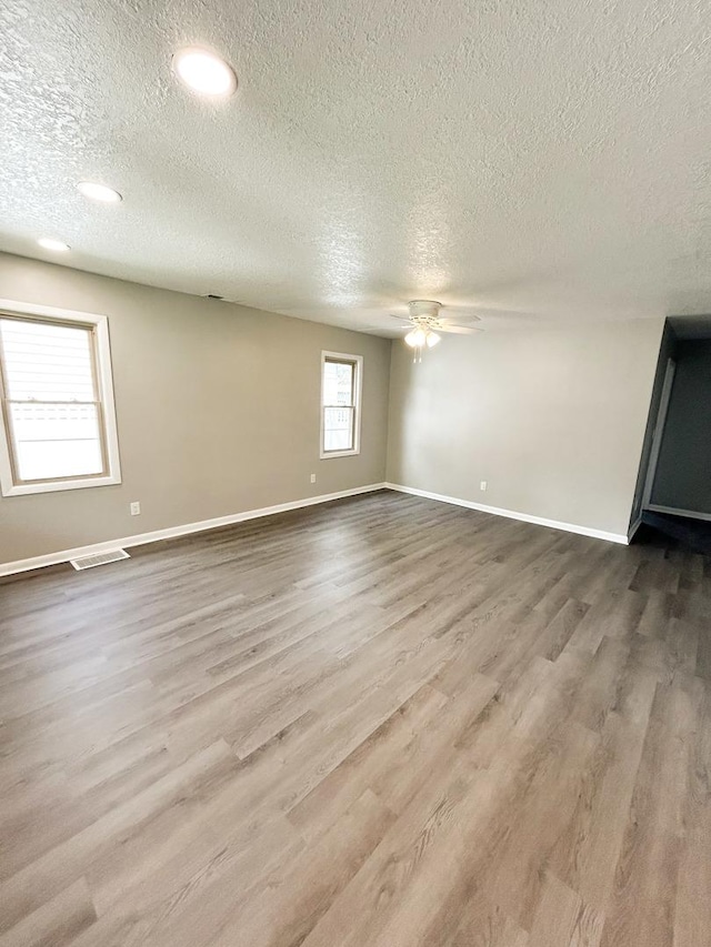 384 N Grand Ave, Bradley, IL 60915 - unfurnished room with a textured ceiling, a ceiling fan, wood finished floors, and baseboards