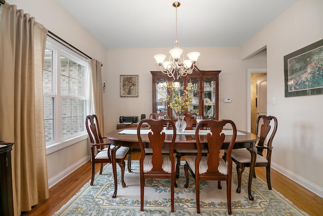 318 Maple St, Beecher, IL 60401 - dining space featuring a chandelier, wood finished floors, and baseboards