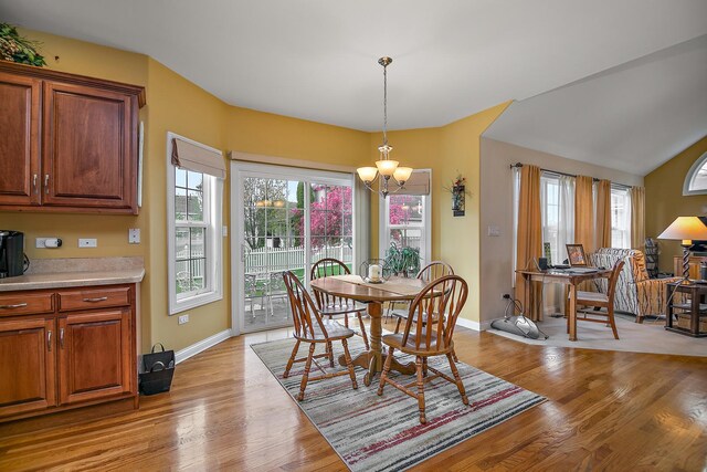 318 Maple St, Beecher, IL 60401 - dining area featuring a chandelier, light wood-style flooring, and baseboards