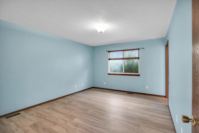 3112 Valerie Dr, Champaign, IL 61822 - unfurnished room with a textured ceiling and light wood-style flooring