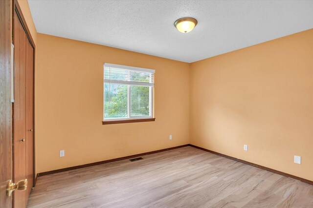 3112 Valerie Dr, Champaign, IL 61822 - unfurnished bedroom with light wood-type flooring and a closet
