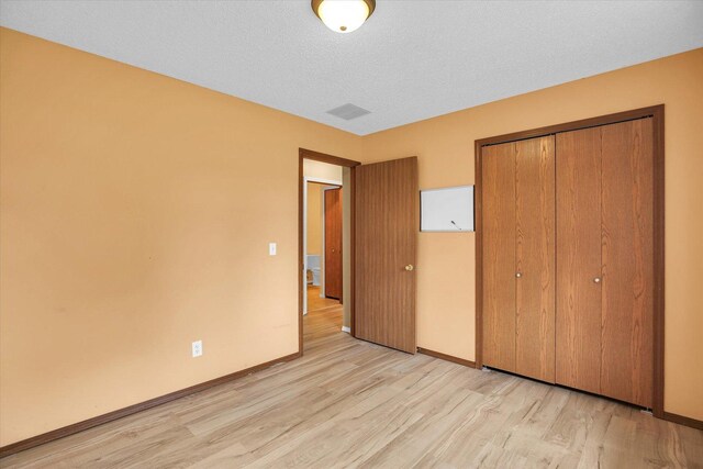 3112 Valerie Dr, Champaign, IL 61822 - unfurnished bedroom with light wood finished floors and a closet