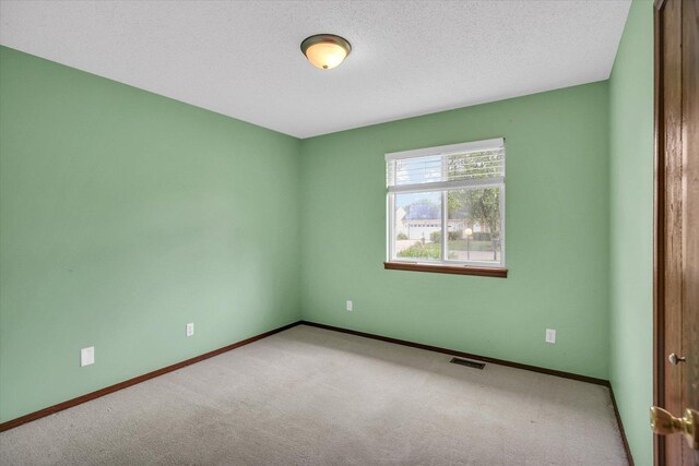 3112 Valerie Dr, Champaign, IL 61822 - spare room featuring carpet floors and a textured ceiling