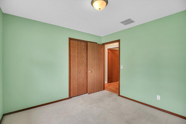 3112 Valerie Dr, Champaign, IL 61822 - unfurnished bedroom featuring a closet and light colored carpet
