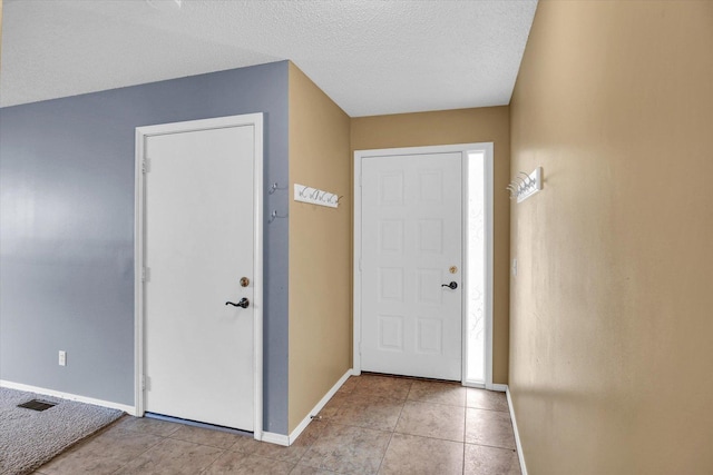 3112 Valerie Dr, Champaign, IL 61822 - entrance foyer with light tile patterned floors and a textured ceiling