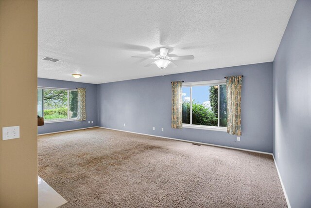 3112 Valerie Dr, Champaign, IL 61822 - spare room featuring a textured ceiling, carpet floors, and ceiling fan