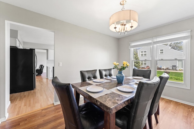 413 Caren Dr, Buffalo Grove, IL 60089 - dining room with a chandelier, light wood-type flooring, and baseboards