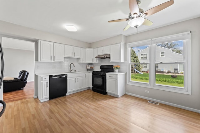 413 Caren Dr, Buffalo Grove, IL 60089 - kitchen featuring black appliances, a sink, light countertops, and white cabinets