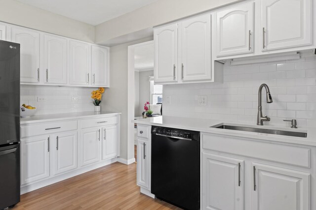 413 Caren Dr, Buffalo Grove, IL 60089 - kitchen featuring black appliances, a sink, tasteful backsplash, and light countertops