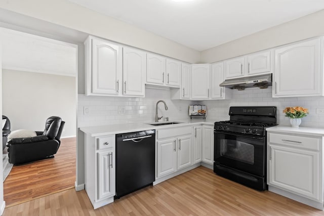413 Caren Dr, Buffalo Grove, IL 60089 - kitchen featuring black appliances, under cabinet range hood, a sink, light wood-style floors, and white cabinets
