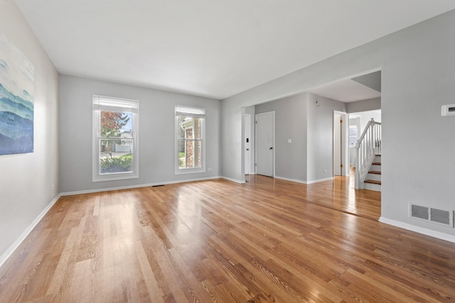 413 Caren Dr, Buffalo Grove, IL 60089 - unfurnished living room with light wood finished floors, stairway, and baseboards