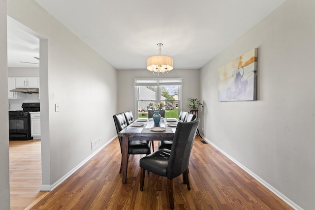 413 Caren Dr, Buffalo Grove, IL 60089 - dining space with wood finished floors, a chandelier, and baseboards