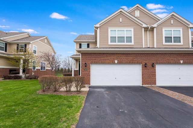 2899 Church Rd, Aurora, IL 60502 - view of front of house with a front yard, driveway, a garage, and brick siding