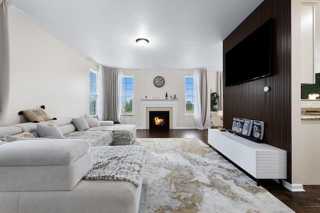 2899 Church Rd, Aurora, IL 60502 - living room with dark wood finished floors, a lit fireplace, and baseboards