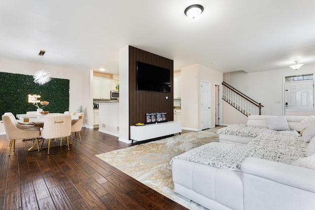 2899 Church Rd, Aurora, IL 60502 - living area featuring dark wood finished floors, baseboards, and stairs