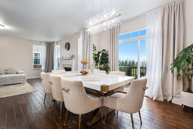 2899 Church Rd, Aurora, IL 60502 - dining room with dark wood-type flooring, a fireplace, and baseboards