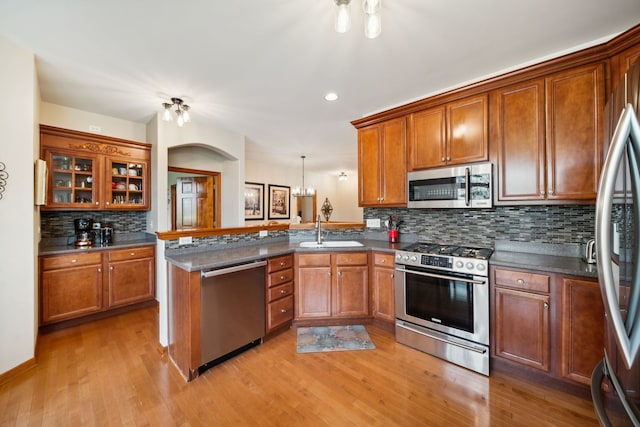 1468 W Remington Ln, Round Lake, IL 60073 - kitchen featuring stainless steel appliances, a sink, a peninsula, brown cabinets, and recessed lighting