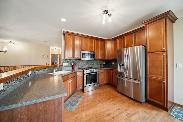 1468 W Remington Ln, Round Lake, IL 60073 - kitchen featuring stainless steel appliances, a sink, decorative backsplash, brown cabinets, and recessed lighting