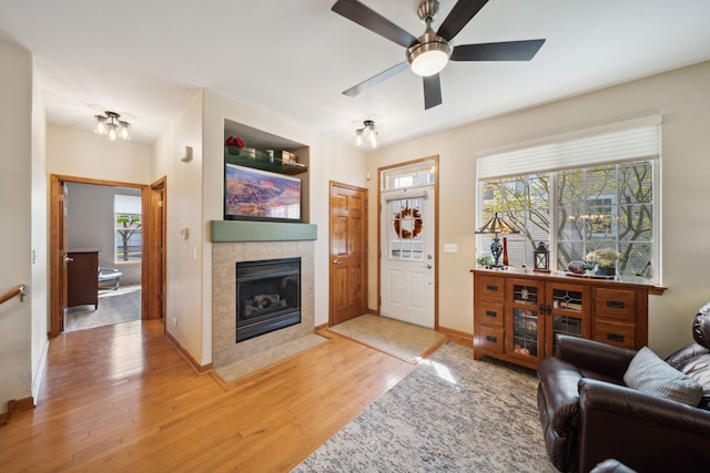 1468 W Remington Ln, Round Lake, IL 60073 - living area with light wood-type flooring, a fireplace, healthy amount of natural light, and a ceiling fan