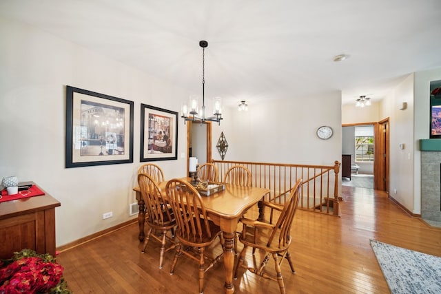 1468 W Remington Ln, Round Lake, IL 60073 - dining room featuring light wood finished floors, a chandelier, and baseboards