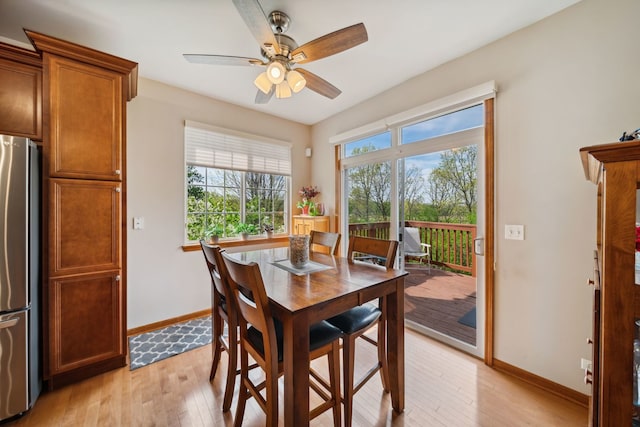 1468 W Remington Ln, Round Lake, IL 60073 - dining area featuring light wood-type flooring, baseboards, and ceiling fan