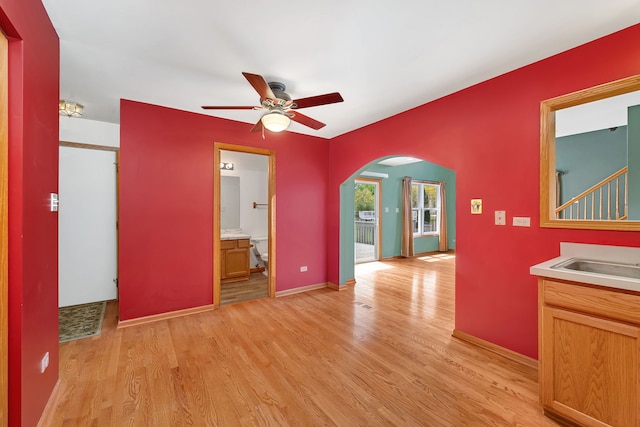 26437 W Deer Path, Channahon, IL 60410 - unfurnished room with arched walkways, a ceiling fan, light wood-style floors, and a sink