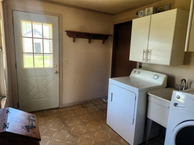 washroom with cabinet space, light flooring, washing machine and clothes dryer, and baseboards