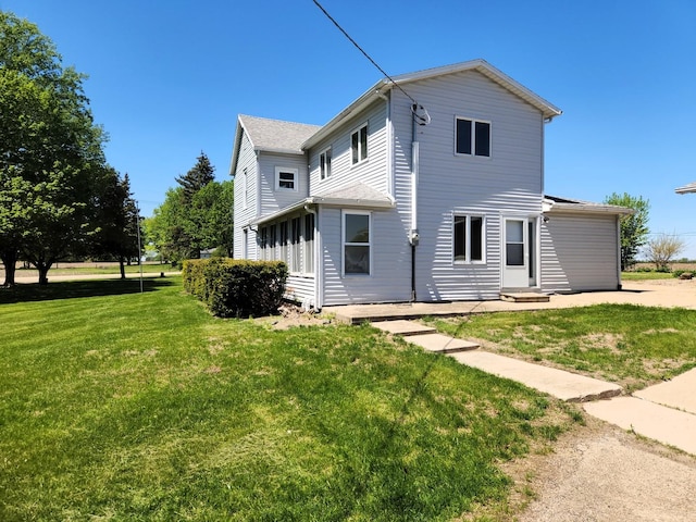 rear view of property featuring a yard