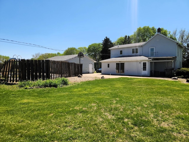 back of property with a chimney and a patio