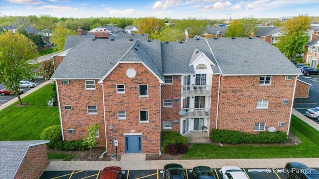 view of property featuring uncovered parking and a residential view