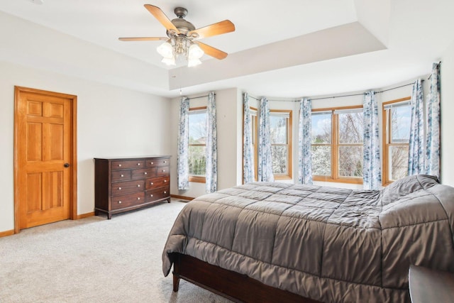 24725 Hanover Ct, Plainfield, IL 60585 - carpeted bedroom with baseboards, a raised ceiling, and a ceiling fan