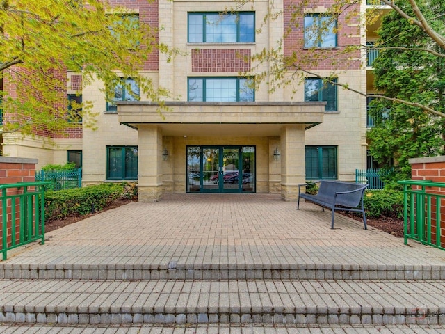 5 W Central Rd Unit 512, Mount Prospect, IL 60056 - doorway to property featuring stone siding, french doors, and fence