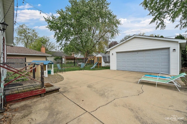 827 Lakewood Pl, Aurora, IL 60506 - view of patio featuring a playground, an outdoor structure, a detached garage, and fence