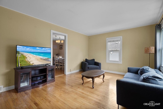 827 Lakewood Pl, Aurora, IL 60506 - living area featuring light wood-style flooring, baseboards, and a chandelier