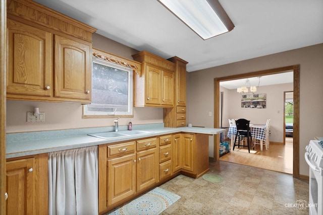 827 Lakewood Pl, Aurora, IL 60506 - kitchen featuring a sink, white range with gas stovetop, light flooring, and light countertops