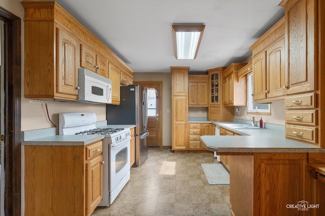 827 Lakewood Pl, Aurora, IL 60506 - kitchen with white appliances, a sink, healthy amount of natural light, and a peninsula