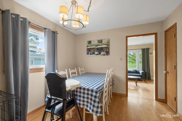 827 Lakewood Pl, Aurora, IL 60506 - dining area with a chandelier, light wood-type flooring, and baseboards