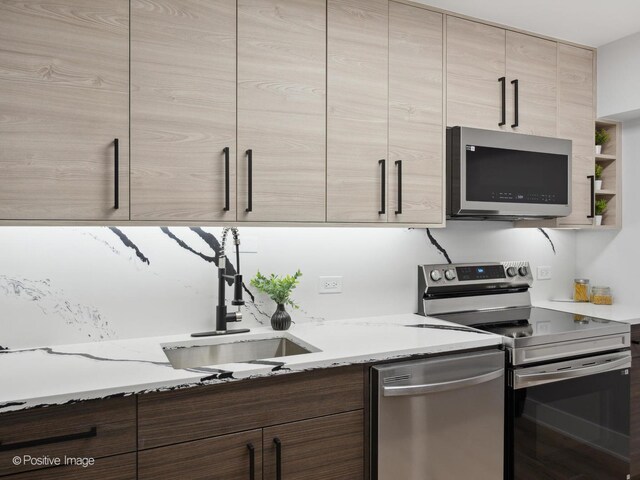 4250 N Marine Dr Unit 1929, Chicago, IL 60613 - kitchen with stainless steel appliances, a sink, light stone counters, and modern cabinets