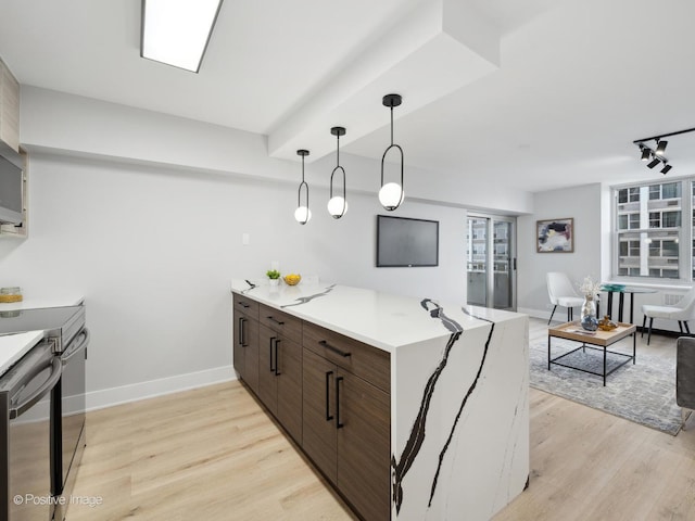 4250 N Marine Dr Unit 1929, Chicago, IL 60613 - kitchen featuring a peninsula, light wood-style flooring, track lighting, and light countertops
