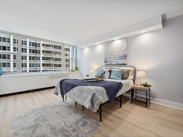 4250 N Marine Dr Unit 1929, Chicago, IL 60613 - bedroom with radiator heating unit, wood finished floors, and baseboards