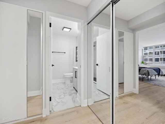 4250 N Marine Dr Unit 1929, Chicago, IL 60613 - bathroom featuring toilet, wood finished floors, and baseboards