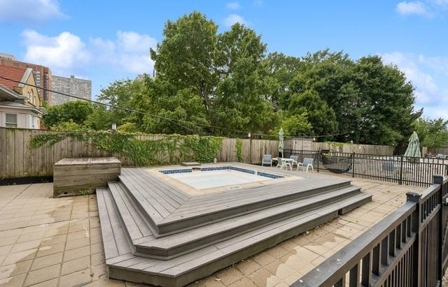 4250 N Marine Dr Unit 1929, Chicago, IL 60613 - wooden terrace featuring a jacuzzi and a fenced backyard