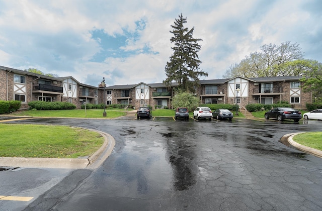 view of asphalt road featuring a residential view and curbs