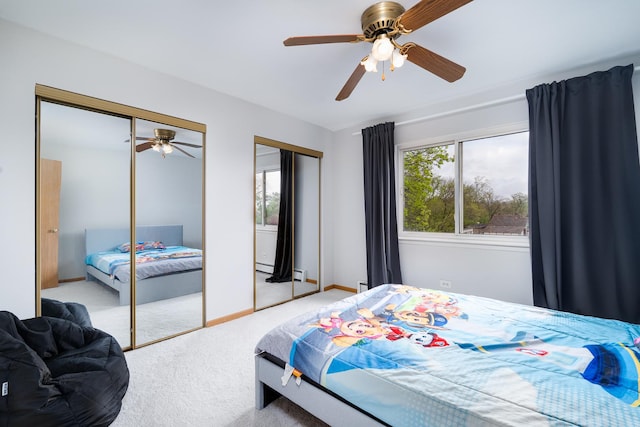 carpeted bedroom featuring two closets, a baseboard heating unit, baseboards, and ceiling fan
