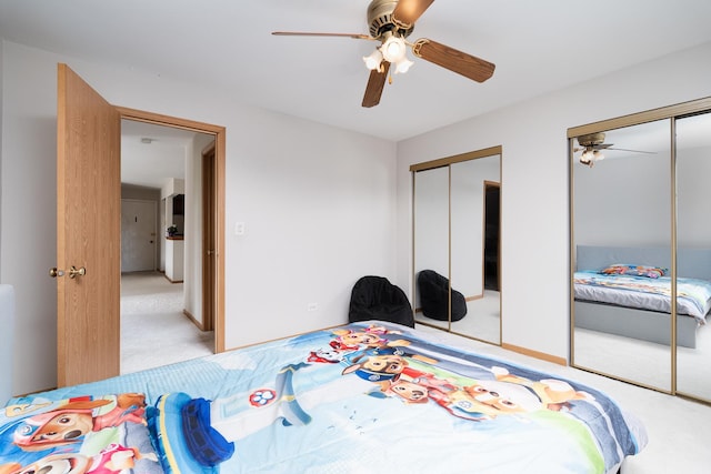 bedroom featuring multiple closets, carpet, and a ceiling fan